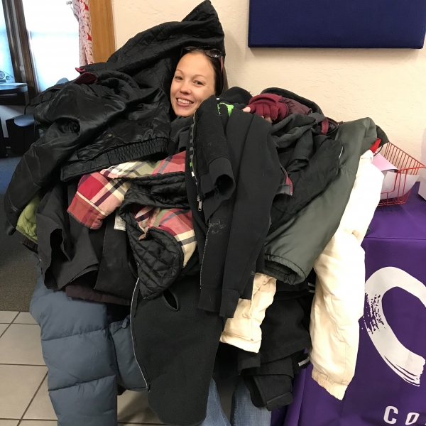 Mary Lawson holding donations brought to the Flagstaff Catholic Charities office.