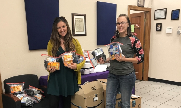 Carly Banks delivering donations to Mary Lawson at Catholic Charities in 2019.